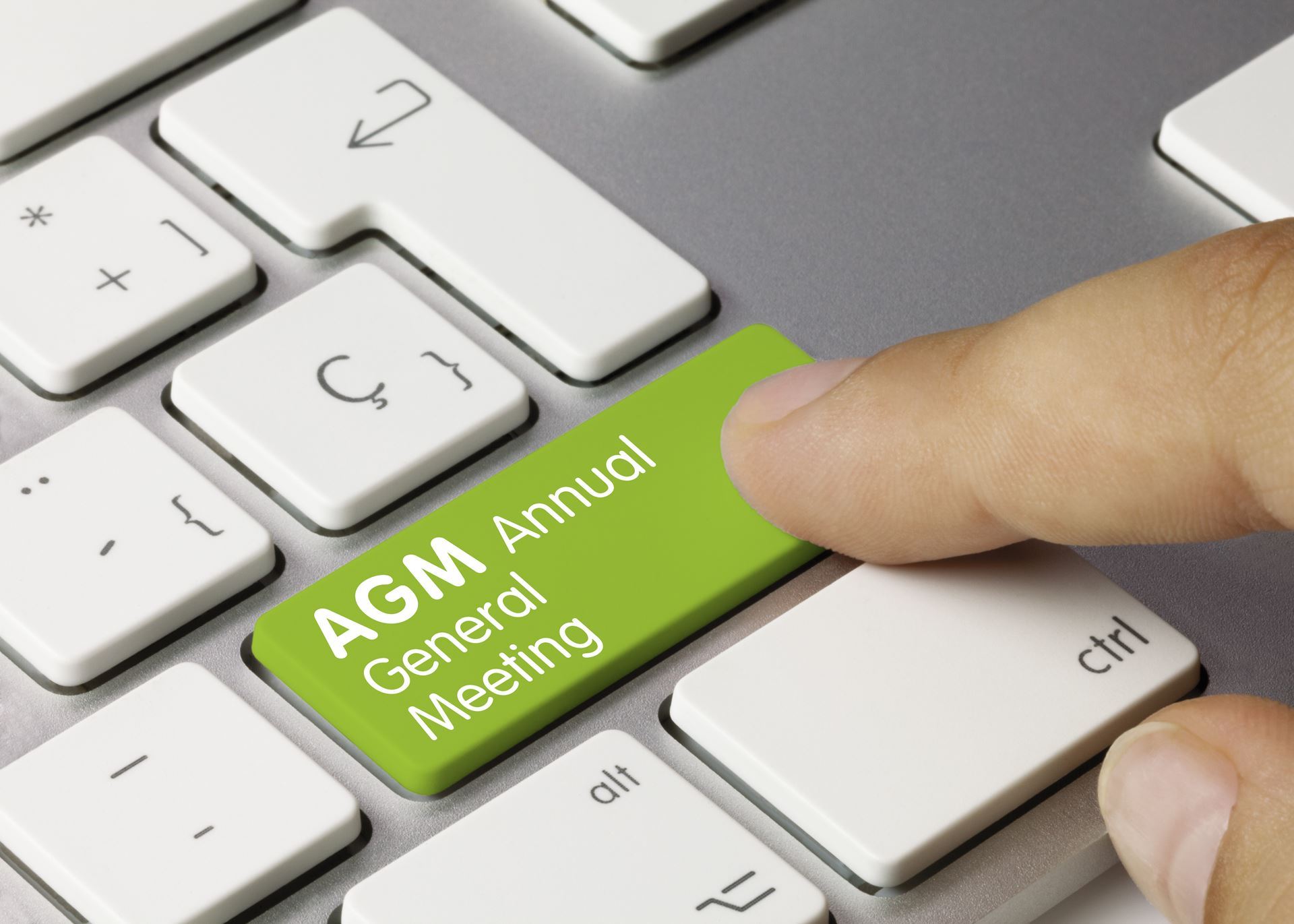 Image of keyboard with words AGM Annual General Meeting, green key with white lettering. 